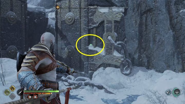 The bird is on a wall next to a large gate - God of War Ragnarok: Lake of Nine, Midgard - secrets, collectibles - Midgard - God of War Ragnarok Guide