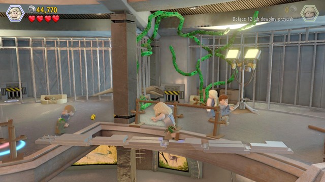 After the bricks spill over the ground, build a footbridge that all of your companions can use to get to the other side - Visitor center | Jurassic Park - walkthrough - Jurassic Park - walkthrough - LEGO Jurassic World Game Guide & Walkthrough