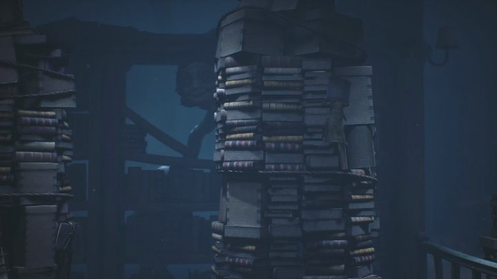 Focusing on the sounds and the woman in the background, you have to sense the right moment to jump to the other stack of books - Little Nightmares 2: The Library - guide, walkthrough description - Chapter 2 - Orphanage - Little Nightmares 2 Guide