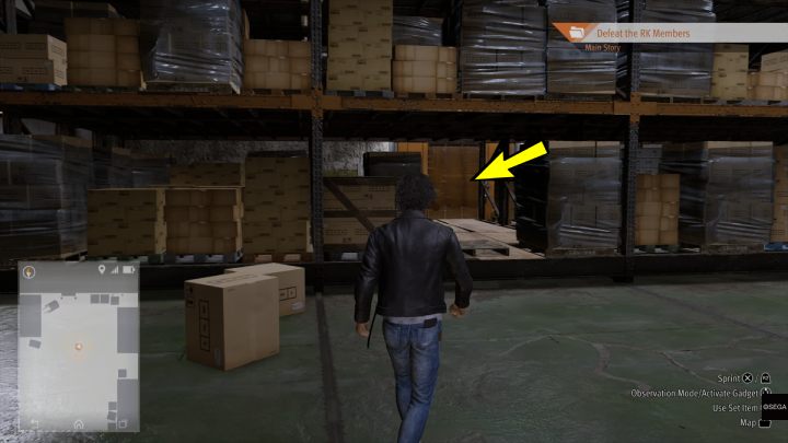 Walk between the cardboard boxes to the next room of the warehouse - Final Chapter - Darkest Before the Dawn - Main Storyline - Lost Judgment Guide