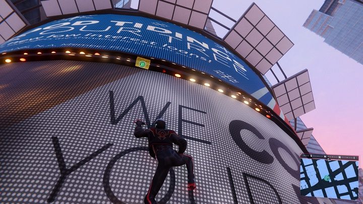 The first capsule in Midtown is located in the western part of the district, between the screens on the building - Spider-Man Miles Morales: Time capsules - all locations, list - Find - Spider-Man Miles Morales Guide