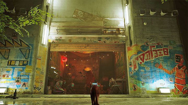 Seamus' flat can be found in one of the side alleys in the slums, which makes it easy to miss - Stray: Seamus flat - where is it in the Slums? - FAQ - Stray Guide, Walkthrough