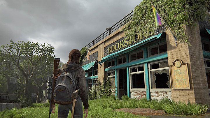 Stop only when you get to the bookstore shown in the picture, which you will recognize by the LGBT flag hanging next to it - The Last of Us 2: Training manuals, passive skills - Character development and equipment upgrades - The Last of Us 2 Guide