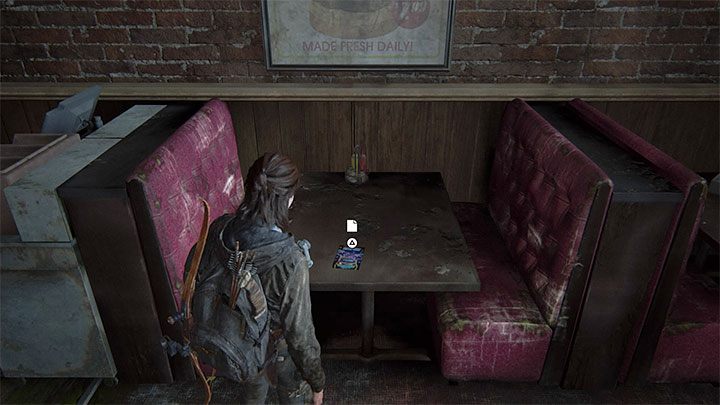 The leaflet sits on one of the tables in the dining area of the arcade - The Last of Us 2: The Flooded City - collectibles, artefacts, coins - Seattle, Day 3 - Ellie - The Last of Us 2 Guide