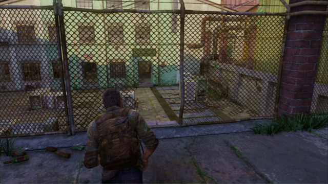 A bit further, you need to squeeze through a hole in the fence where Joel will take cover behind the crates automatically - The Slum (text & maps) | The Quarantine Zone | The Last of Us Walkthrough - The Quarantine Zone - The Last of Us Guide