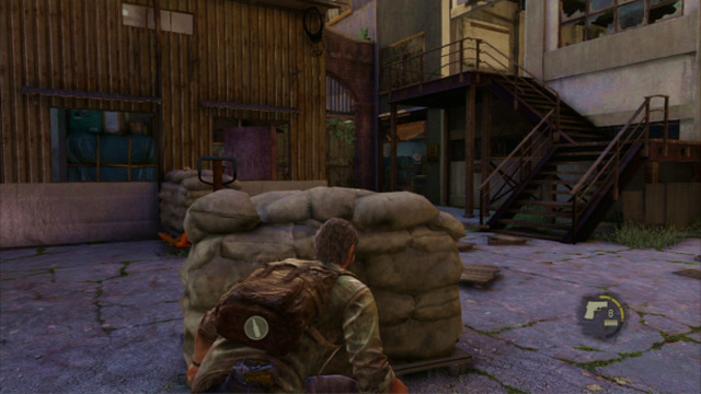 After you deal with the enemies, go downstairs to eliminate the third one on the ground floor of the warehouse - The Slum (text & maps) | The Quarantine Zone | The Last of Us Walkthrough - The Quarantine Zone - The Last of Us Guide
